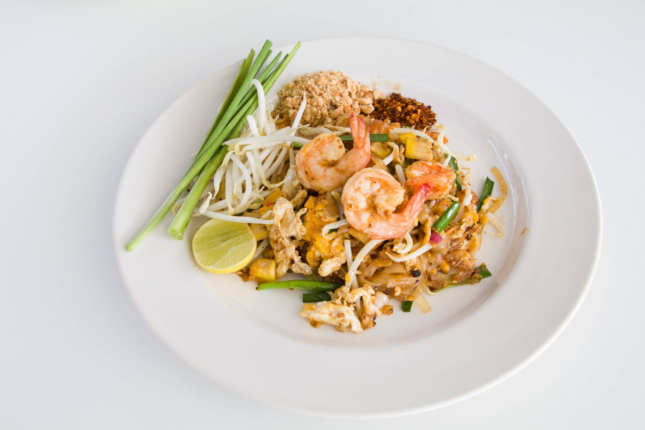 Traditional Pad Thai Of A White Plate In Front Of A White Background